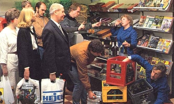 People standing in line to return bottles to staff in retail shop