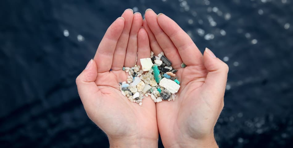 Hands holding microplastics