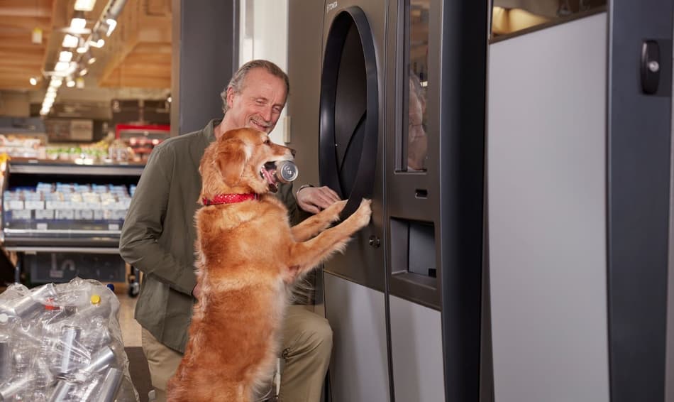 Man and dog returning containers in R1 reverse vending machine