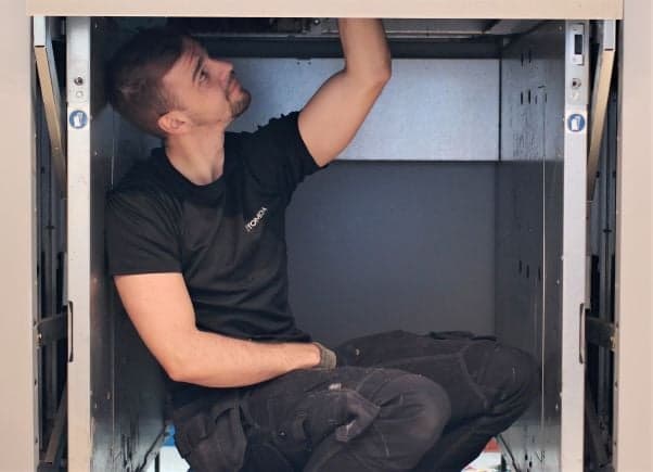 Image of Tuukka working on reverse vending machine
