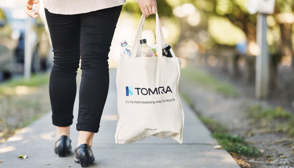 Woman returning containers to store in reusable bag