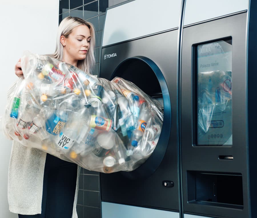 Woman recycling in R1 TOMRA machine