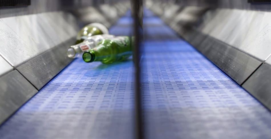 Bottles rolling on conveyor