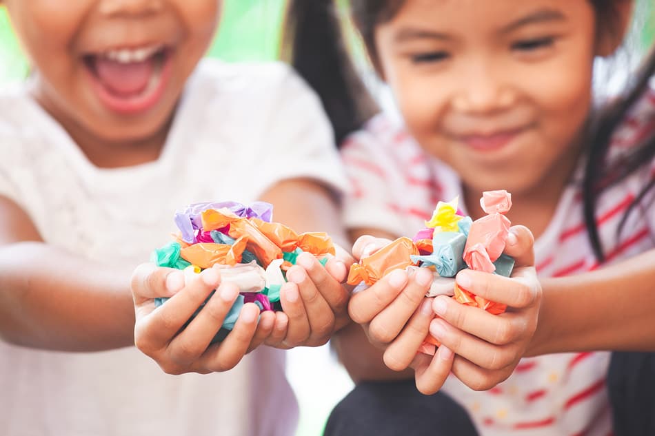 Children with hands full of confectionery